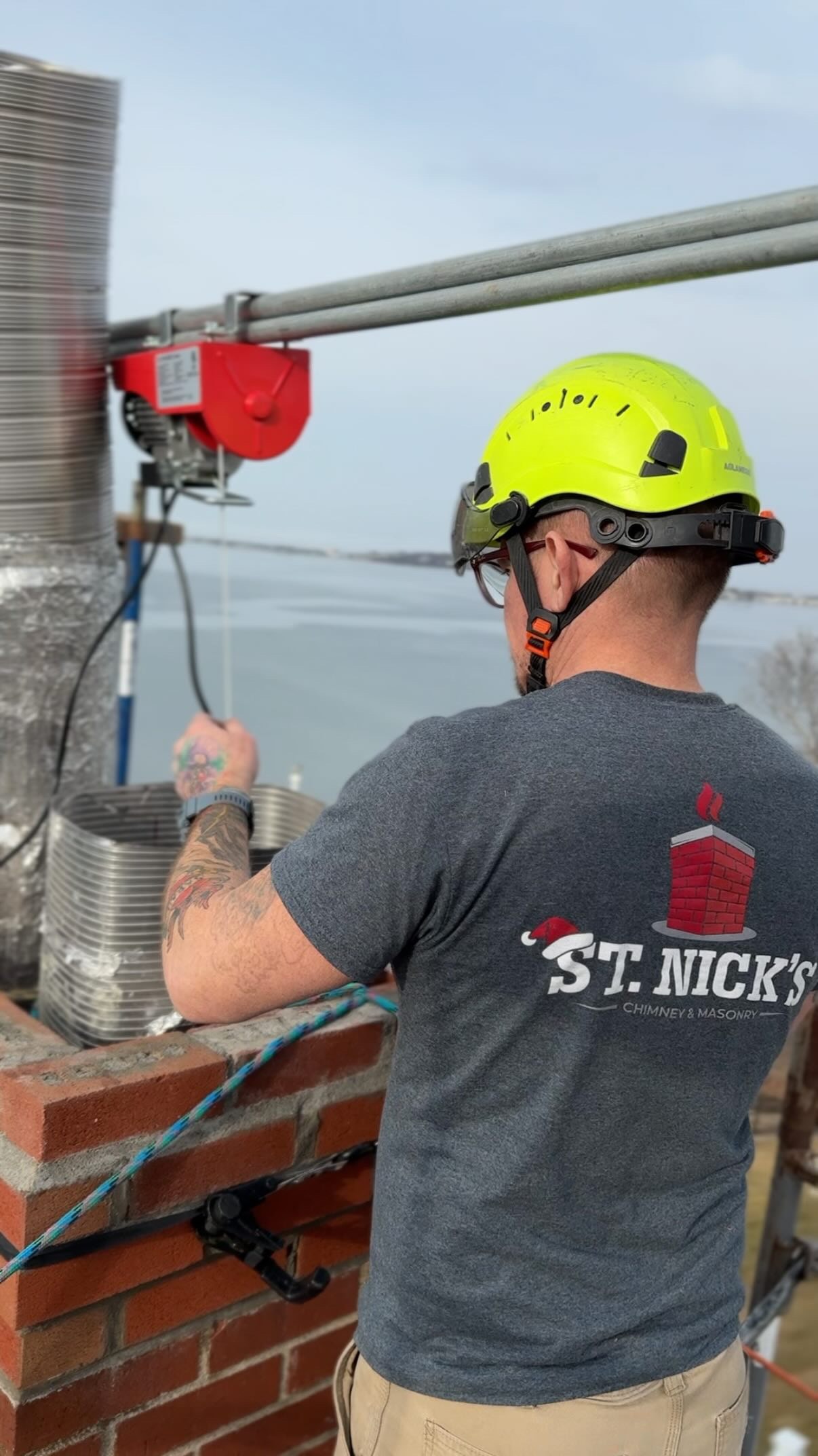 St. Nick’s Chimney Service professional working on a masonry chimney in Hingham